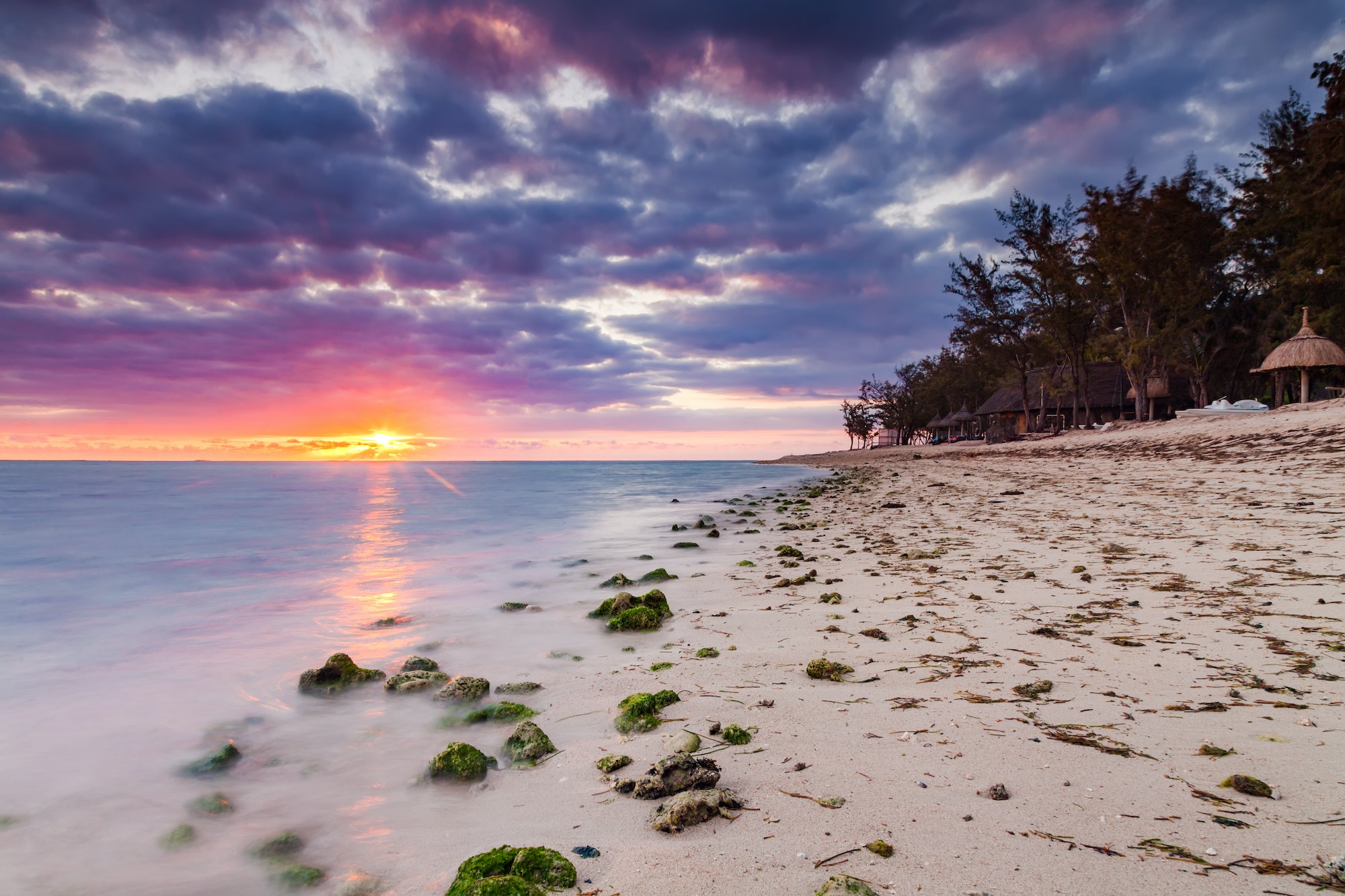 Beautiful sunset on the beach in a tropical resort at Reunion island.